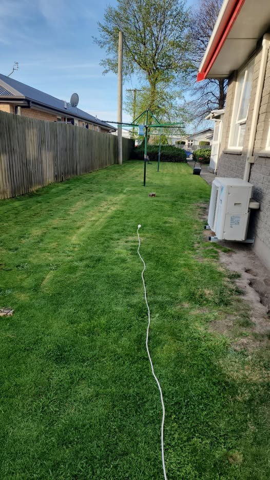 Freshly mowed lawn in a Christchurch backyard with a clothesline — real Davis Gardening work
